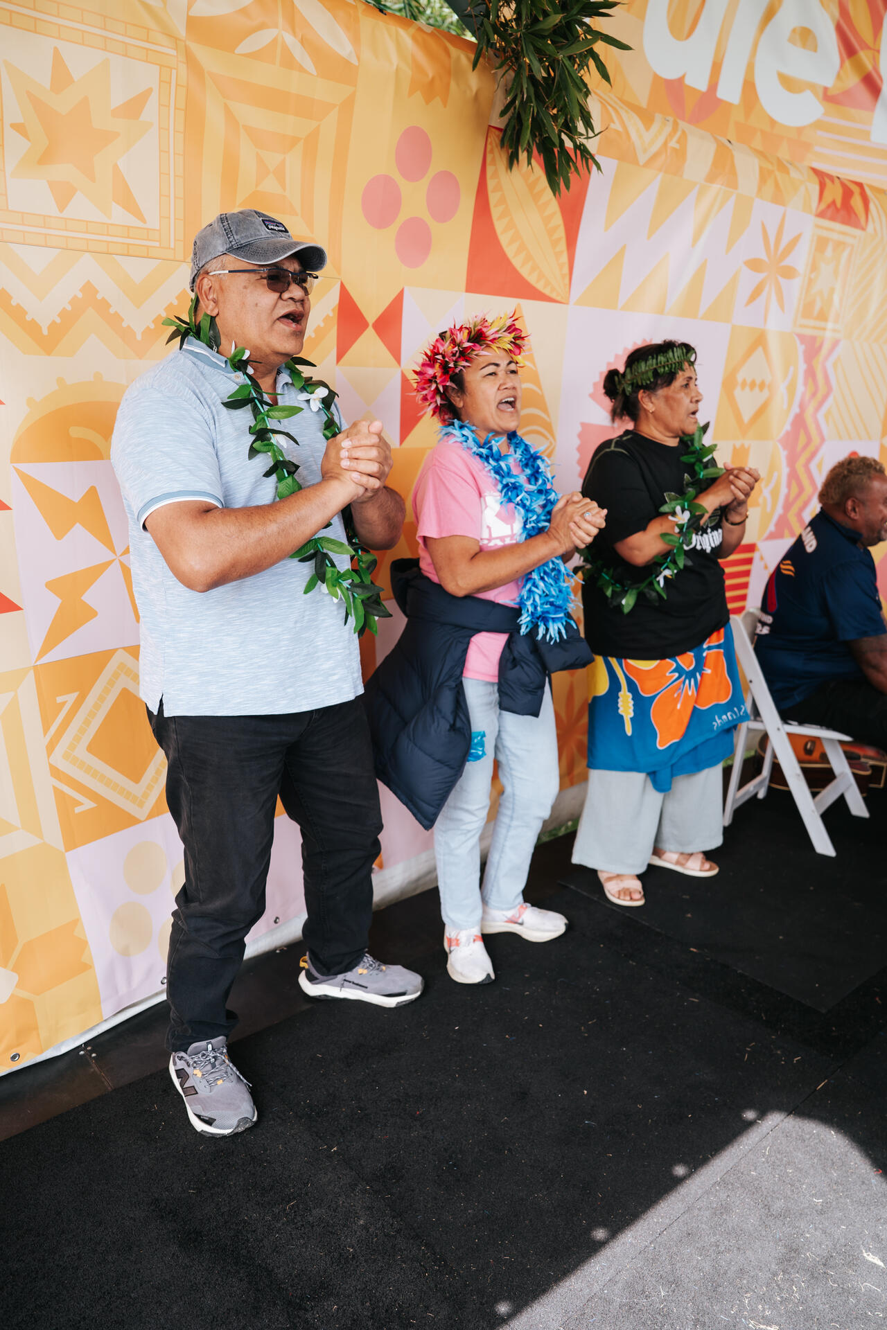 Elders singing with lei garlands