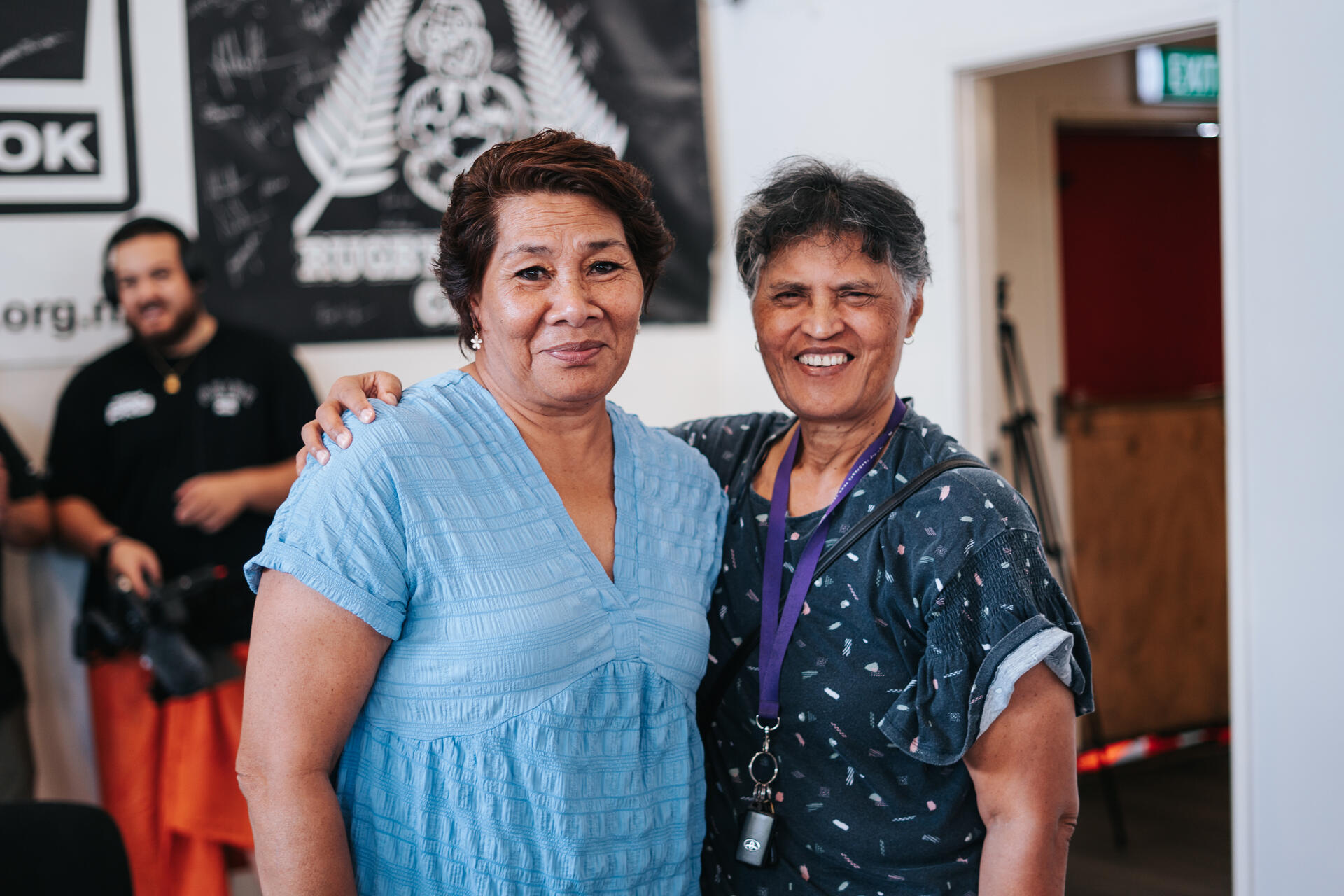 Two community elders smiling together at event