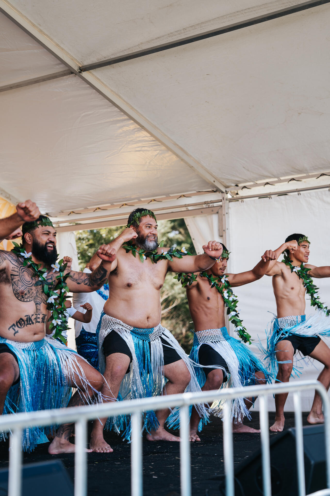 Male dancers performing on stage in traditional Tokelauan attire