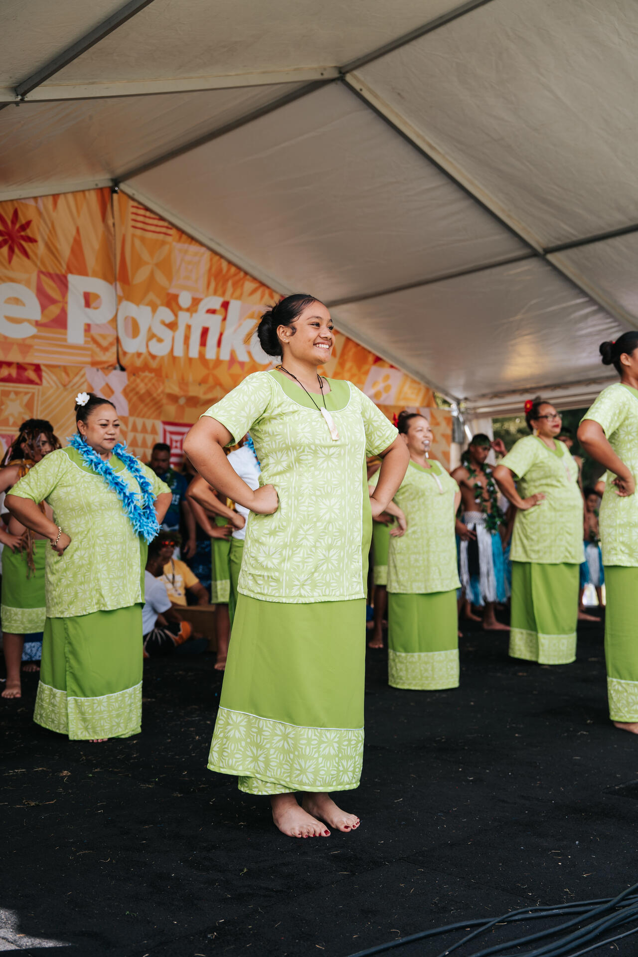 Women performing in matching green outfits at Pasifika Festival