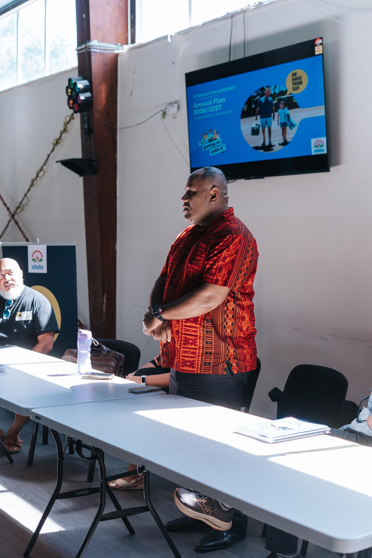 Leader presenting annual plan at community meeting