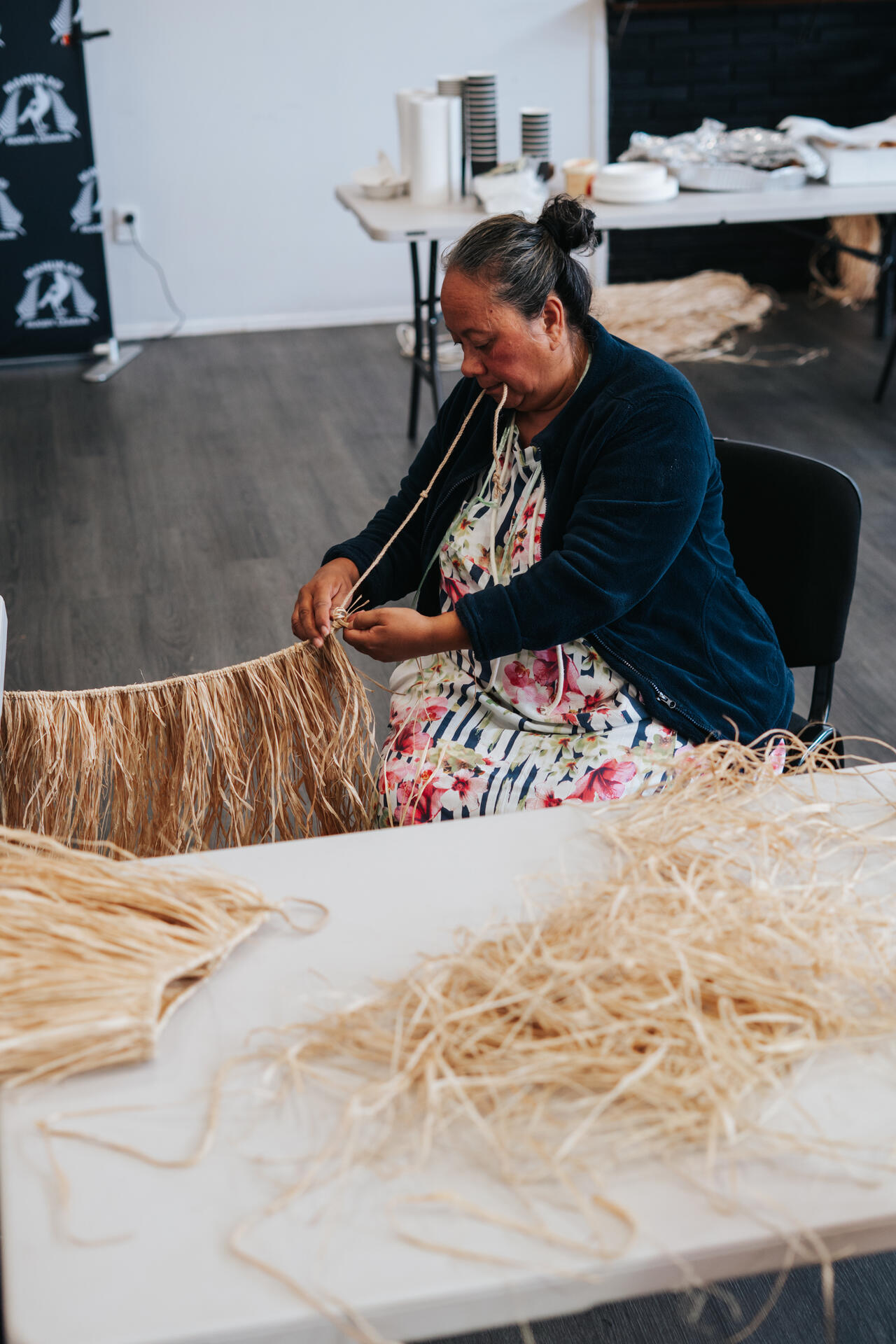 Woman weaving traditional skirt with natural fibres