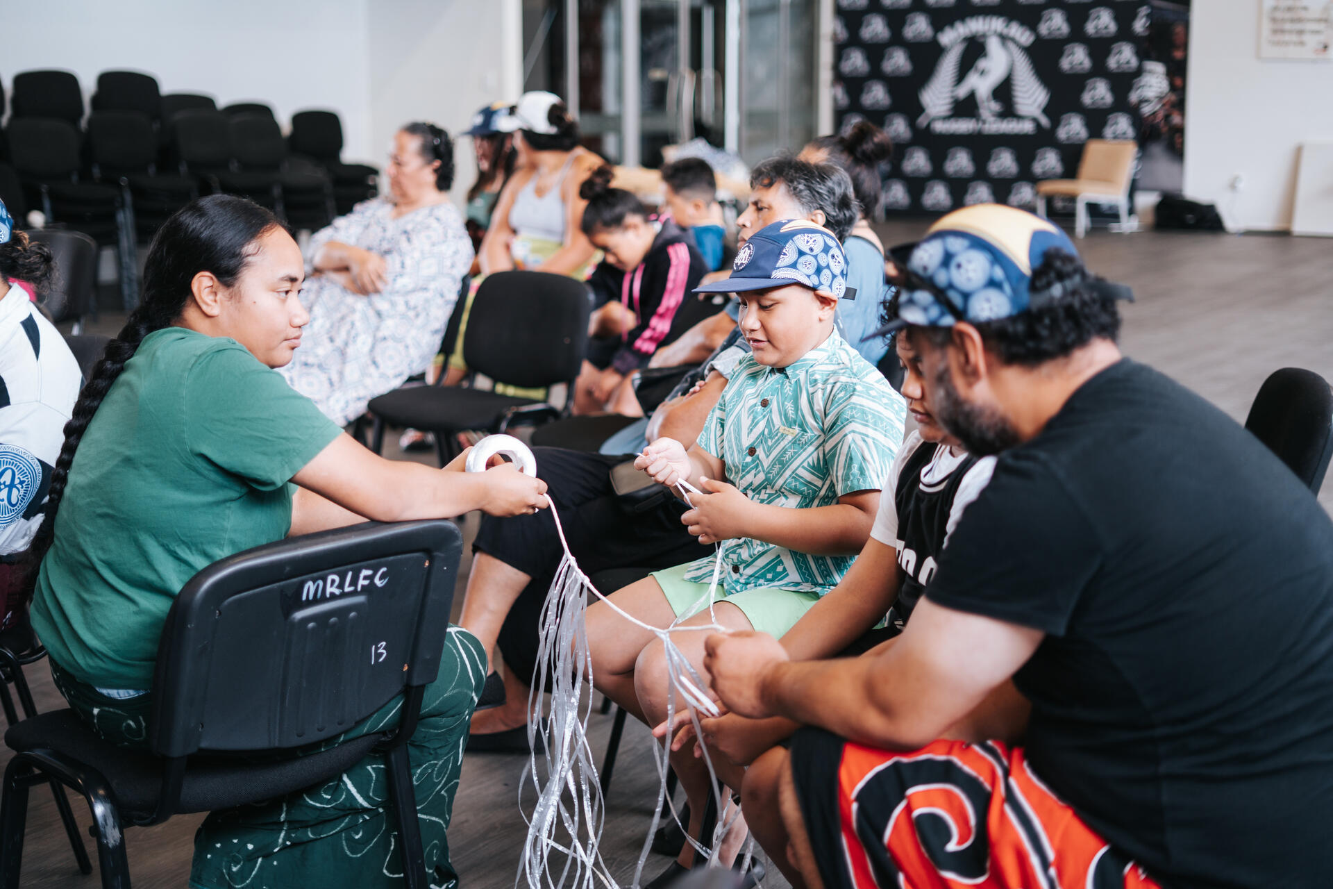 Youth learning traditional weaving