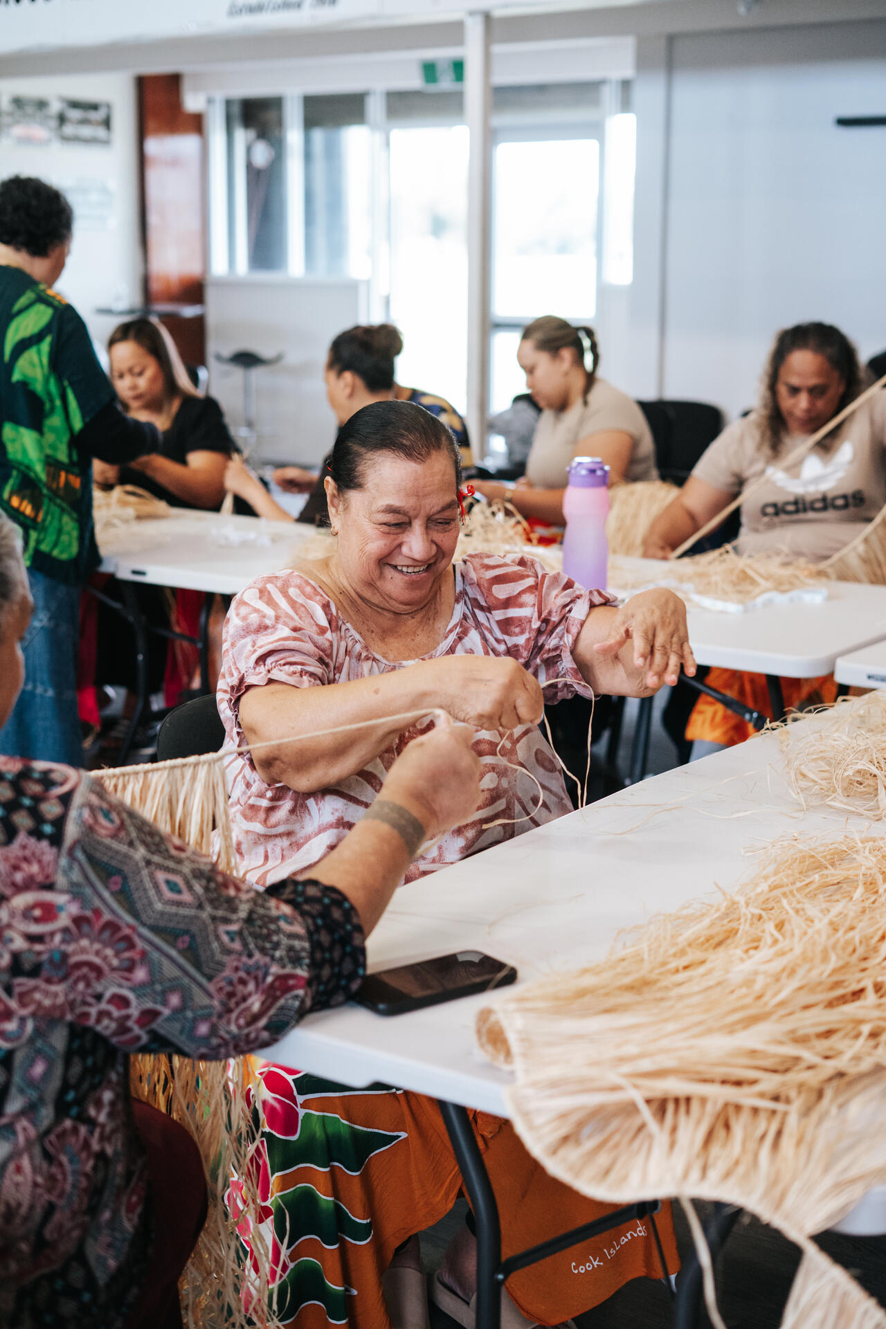 Women weaving traditional crafts at community workshop