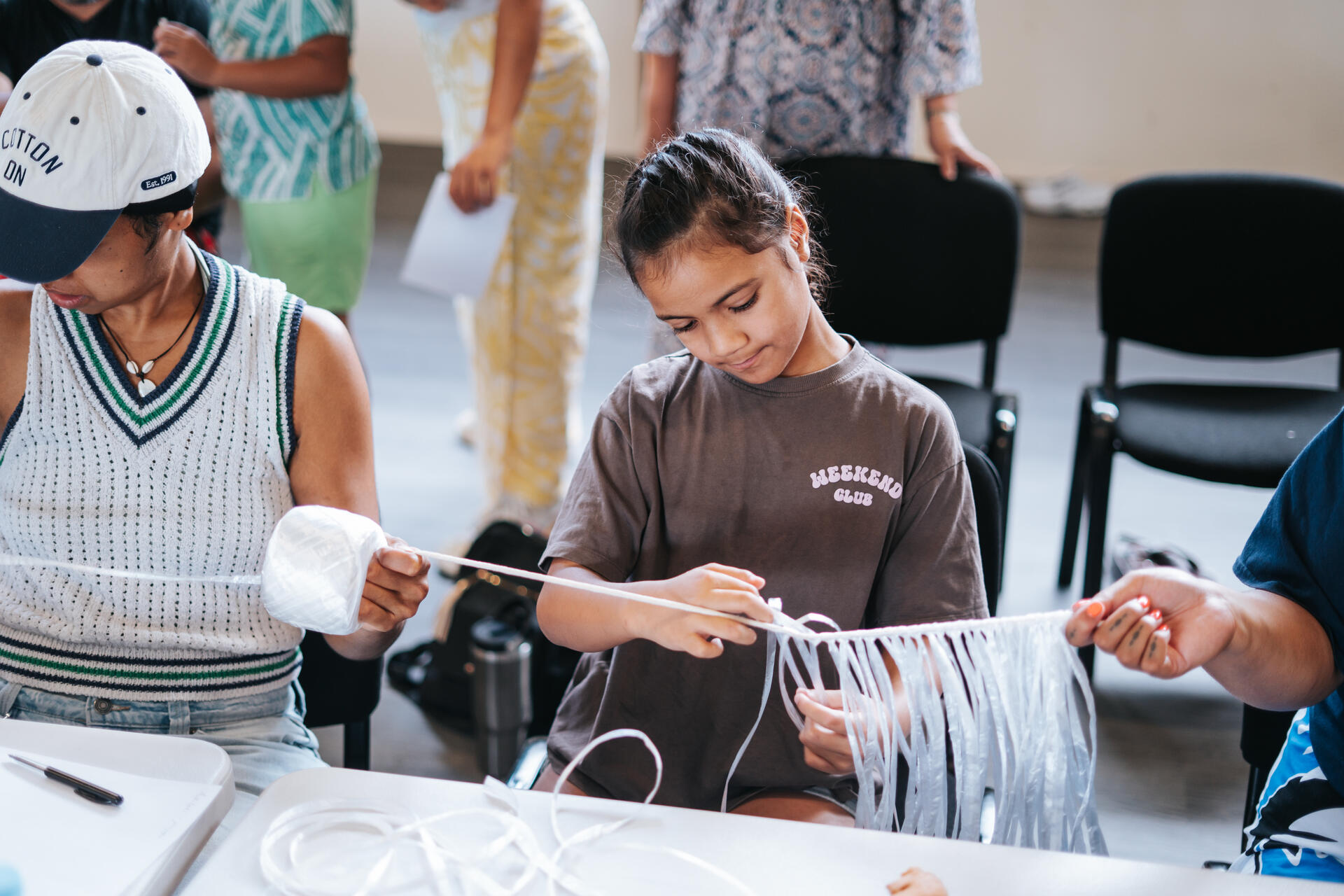 Youth learning traditional craft skills at workshop