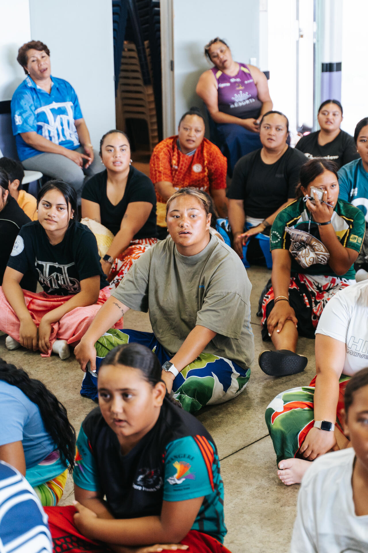 Youth sitting together on floor during community meeting